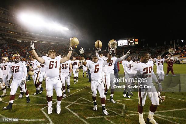 Kevin Sheridan, Jeff Smith, and teammates of the Boston College Eagles celebrate their victory as they walk off the field during the game against the...