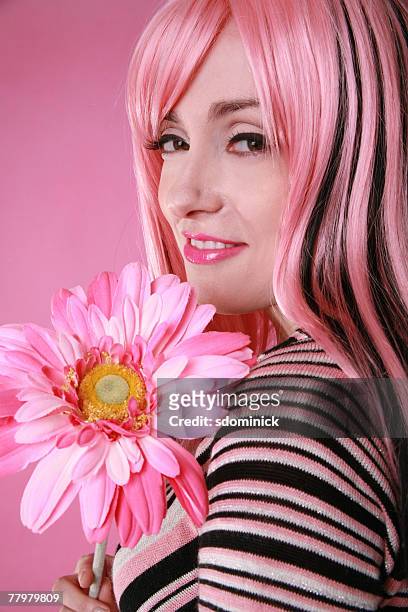 70's style modeling holding an artificial daisy. - false daisy stock pictures, royalty-free photos & images