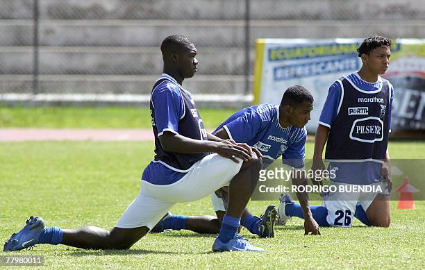 Ecuadorean footballers Alex Bola?os, Oscar Bagui and Jeferson Montero do some stretching during a training session at the Eloy Alfaro military...