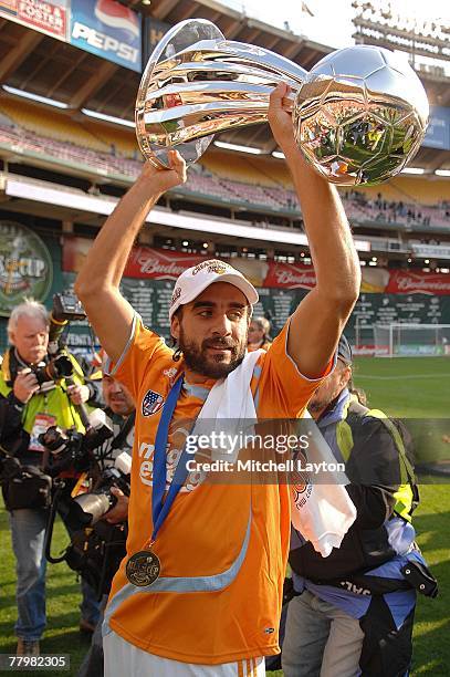 Dwayne De Rosario of the Houston Dynamo celebrates with the trophy after defeating the New England Revolution by a score of 2-1 to win the 2007 Major...