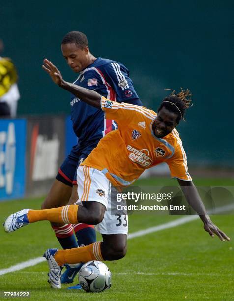 Joseph Ngwenya of the Houston Dynamo is tripped up by Khano Smith of the New England Revolution during the 2007 Major League Soccer Cup at RFK...