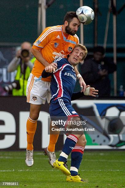 Brian Mullan of the Houston Dynamo Taylor Twellman of the New England Revolution during the 2007 Major League Soccer Cup at RFK Stadium on November...