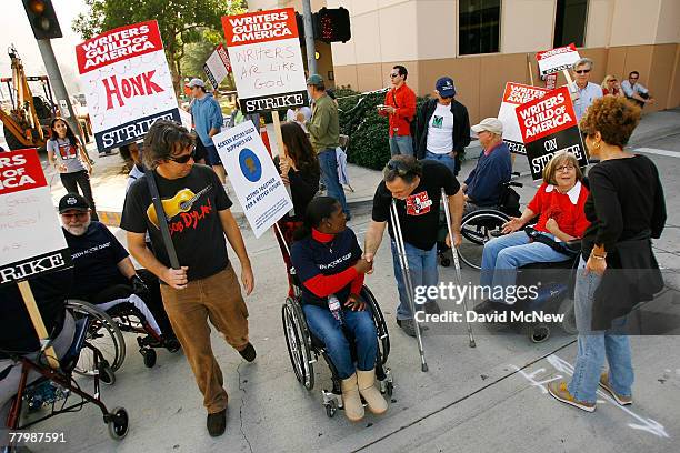 Members of the SAG/AFTRA/EQUITY Performers with Disabilities Committee join striking Hollywood writers on the picket line outside Warner Brothers...