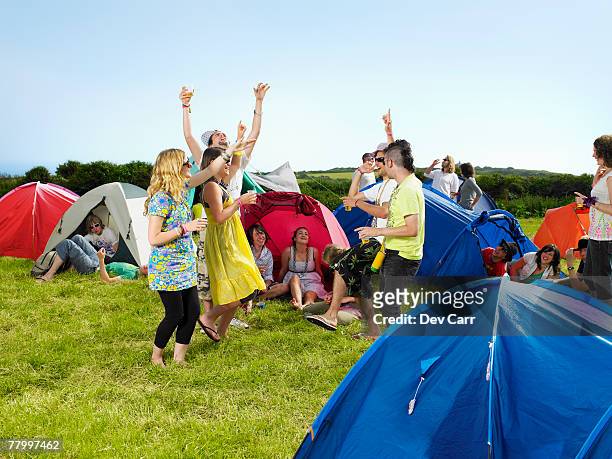 group partying outside tents - music festival grass stock pictures, royalty-free photos & images