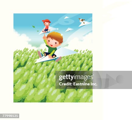 Boy and a girl flying on paper airplanes over a field Boy and a girl flying on paper airplanes over a field