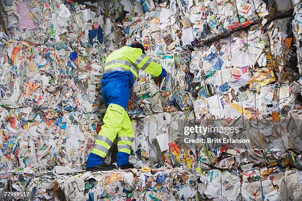 man leaning on wall of recycling. - vuilnisman stockfoto's en -beelden