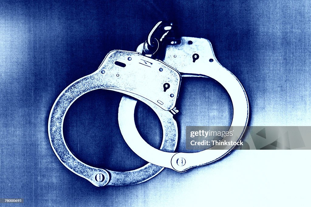 Blue tone of locked handcuffs.