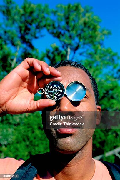Guy Using A Compass 48 Black Person Holding Compass Stock Photos, High-Res Pictures, and ...