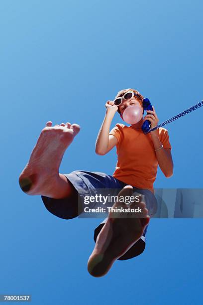woman with telephone and bubble gum - teenage girls barefoot stock-fotos und bilder