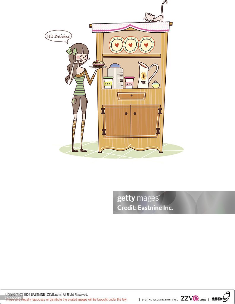 Woman standing near a kitchen cabinet and eating a cake