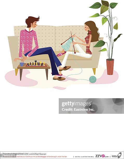 side profile of a woman knitting with a man sitting in front of her on the couch - couple having coffee stock illustrations