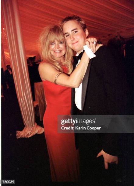Actress Goldie Hawn hugs Boston Russell, son of her companion Kurt Russell, at the White House for an official dinner honoring Indian Prime Minister...