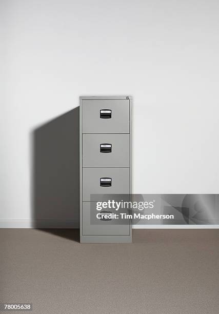 filing cabinet against wall. - archivieren stock-fotos und bilder