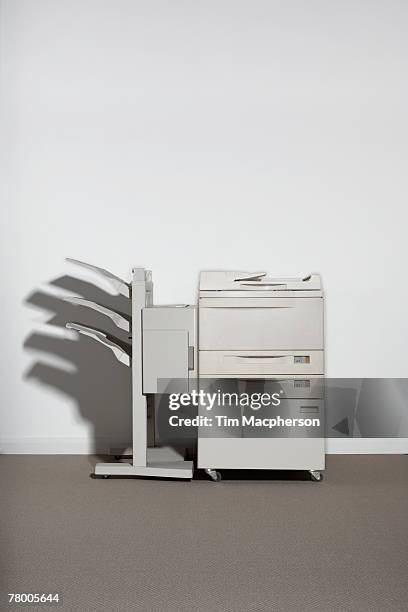a photocopier against a white wall. - copying fotografías e imágenes de stock