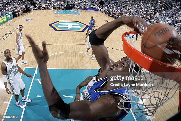 Dwight Howard of the Orlando Magic dunks in front of David West of the New Orleans Hornets on November 19, 2007 at the New Orleans Arena in New...