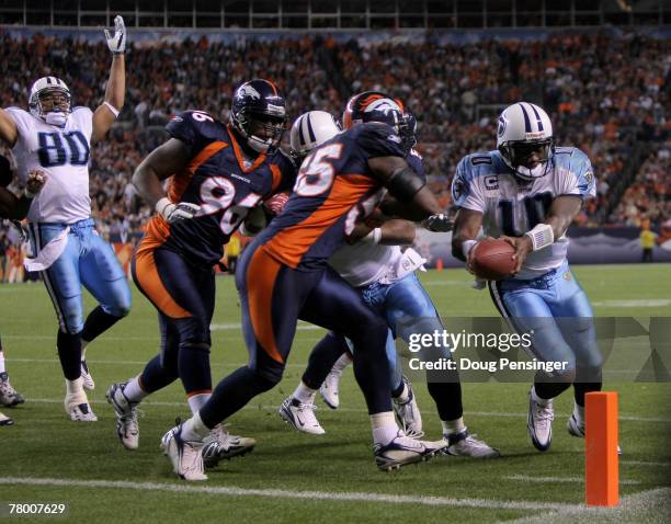 Quarterback Vince Young of the Tennessee Titans gets around linebacker D. J. Williams of the Denver Broncos and gets the ball over the endzone line...
