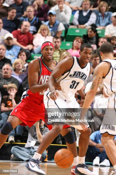 Jarron Collins of the Utah Jazz looks for the ball as his brother Jason Collins of the New Jersey Nets guards him on November 19, 2007 at the...