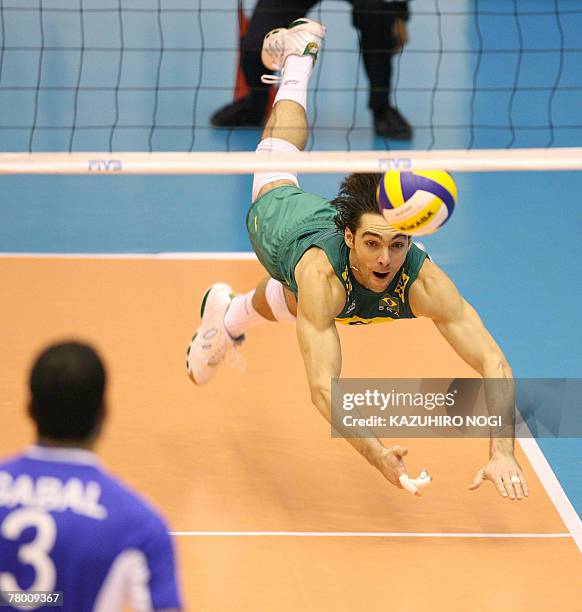 Brazilian volleyball star Gilberto Godoy Filho "Giba" dives to hit a return against Egypt during a match of the FIVB Men's World Cup volleyball...