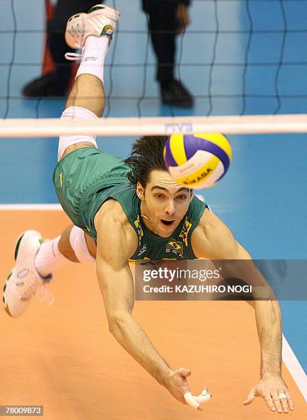 Brazilian volleyball star Gilberto Godoy Filho "Giba" dives to hit a serve by Egypt during a match of the FIVB Men's World Cup volleyball tournament...