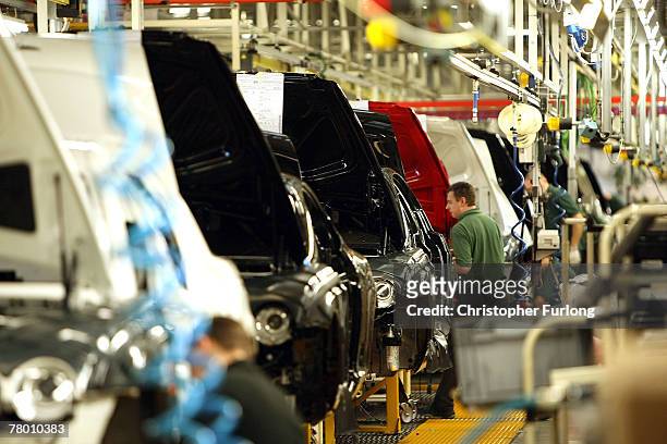 Worker builds a Bentley car on the production line at the Bentley Motors Factory on 19 November, 2007 in Crewe, England. The Cheshire based company...