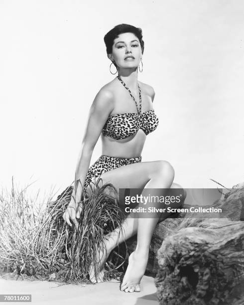 American actress and dancer Cyd Charisse in a leopard-skin bikini, circa 1955.
