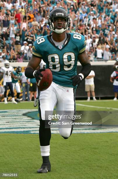 Marcedes Lewis of the Jacksonville Jaguars catches a pass for a touchdown against the San Diego Chargers at Jacksonville Municipal Stadium on...