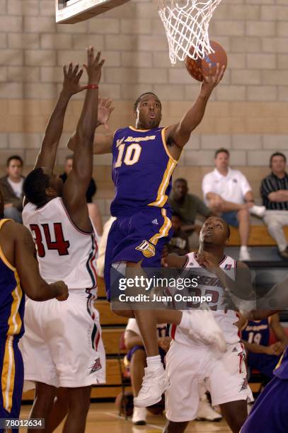 Errick Craven of the Los Angeles D-Fenders goes to the basket against Noel Felix and Lodrick Stewart of the Anaheim Arsenal during a D-League...