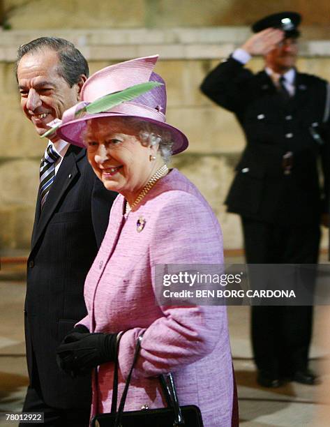 Malta's Prime Minister Lawrence Gonzi and Queen Elizabeth II of England walk together 20 November 2007 during a visit to Valletta. The Queen and the...