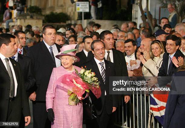 Malta's Prime Minister Lawrence Gonzi and Queen Elizabeth II of England walk together 20 November 2007 during a visit to Valletta. The Queen and the...