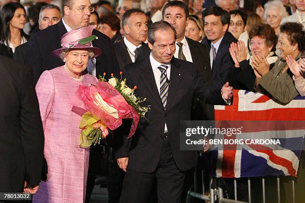 Malta's Prime Minister Lawrence Gonzi and Queen Elizabeth II of England walk together 20 November 2007 during a visit to Valletta. The Queen and the...