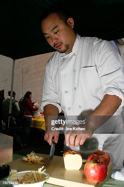 Momofuku chef David Chang volunteer at the 007 City Harvest Pre-Thanksgiving Mobile Market on November 20, 2007 in New York City