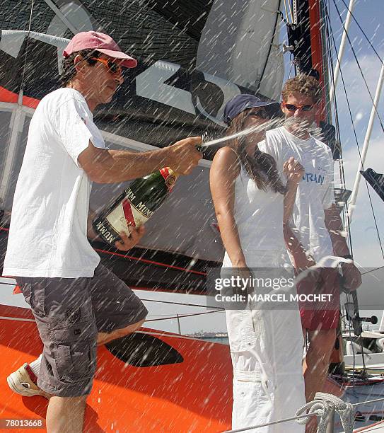 French yachtmen Marc Guillemot and Charles Caudrelier spray champagne onboard the 60 feet monohull "Safran" upon their arrival to Salvador, Bahia,...