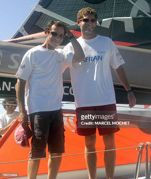 French yachtmen Marc Guillemot and Charles Caudrelier smile onboard the 60 feet monohull "Safran" upon their arrival to Salvador, Bahia, Brazil 20...