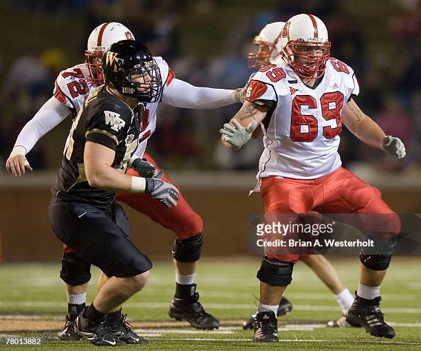 Kalani Heppe of the North Carolina State Wolfpack provides pass protection versus the Wake Forest Demon Deacon defenders at BB&T Field November 17,...