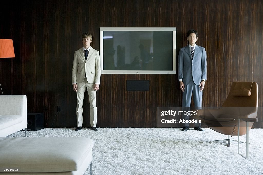 Two young man standing in a room