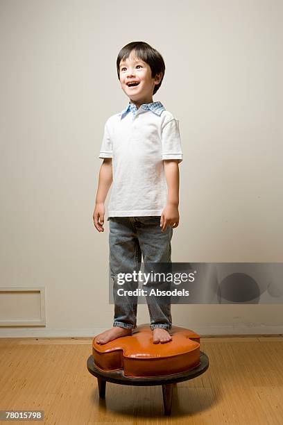 a boy on the stool - cute japanese boy stock-fotos und bilder