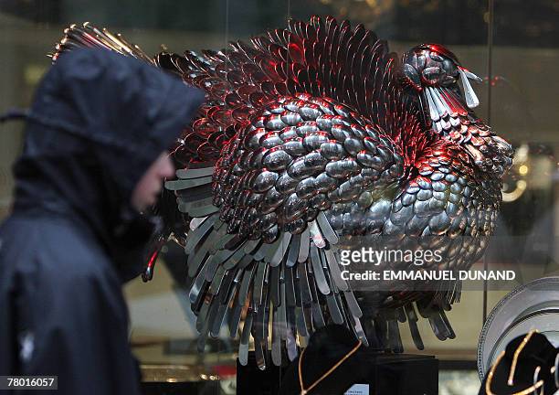 Boy walks past a turkey made of silver on display at a store ahead of Thanksgiving celebrations in New York, 20 November 2007. Thanksgiving, an...