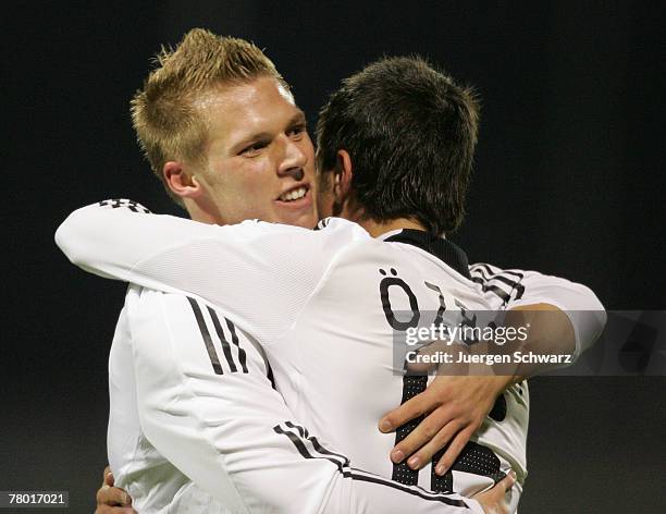 Rouwen Hennings of Germany is hugged by team-mate Baris Oezbek after scoring during the U21 qualifier between Luxembourg and Germany at theJosy...