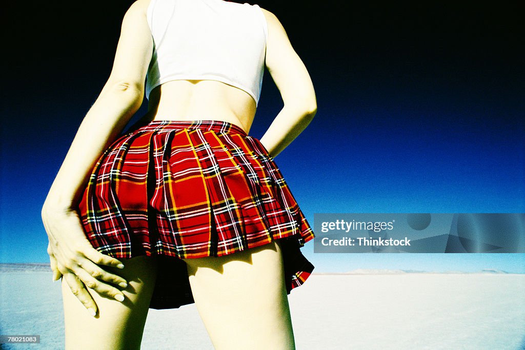 Woman in plaid skirt from behind