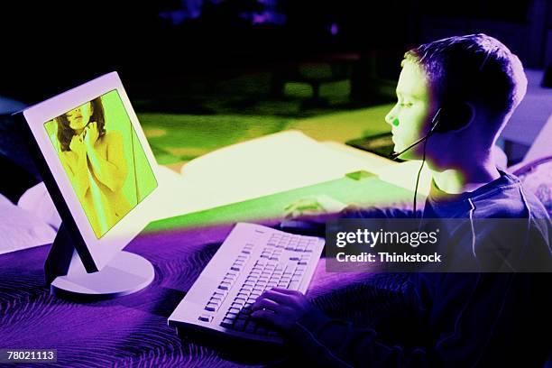 teenage boy at computer looking at nude woman - teen computer fotografías e imágenes de stock