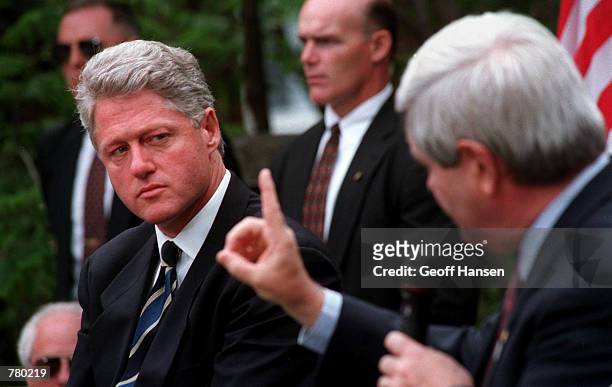 President Bill Clinton listens to Speaker of the House Newt Gingrich during a joint appearance at the local senior center in Claremont, NH, June 11,...