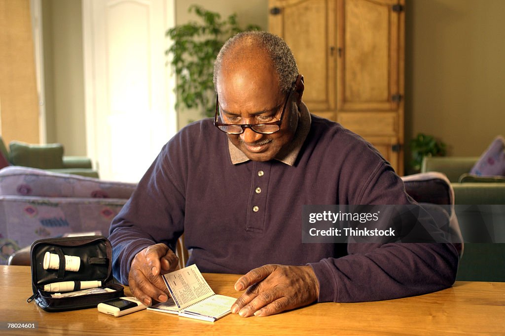 Man reading manual for blood test kit