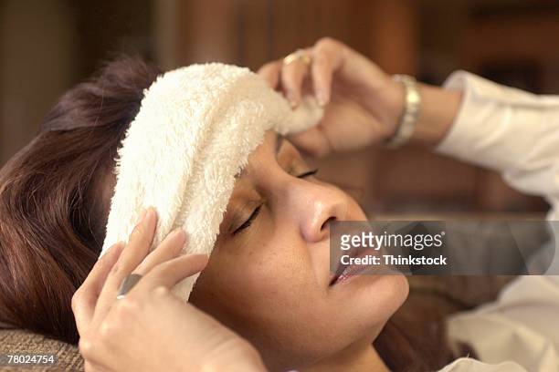 woman with cloth on forehead - rag stock pictures, royalty-free photos & images