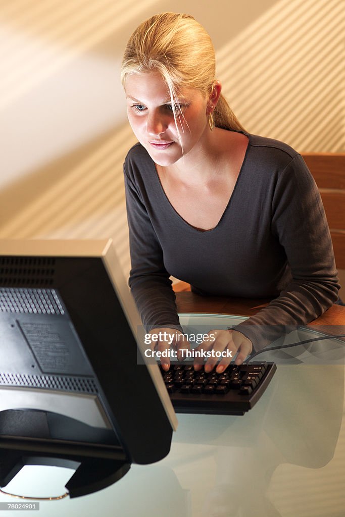 High angle of a girl working on her computer doing her homework