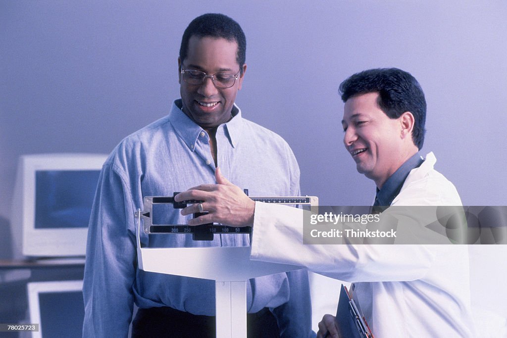 Blue tone of a doctor weighing a male patient