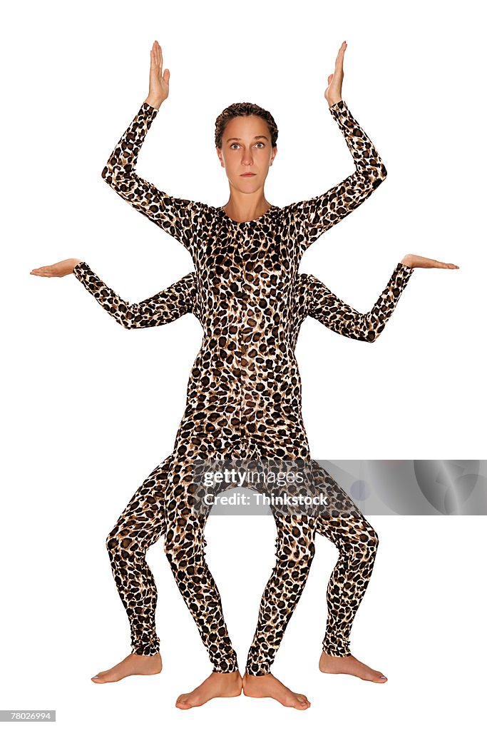 Two Women In Matching Leopard Print Outfits Create An Optical Illusion Of  One Person With Four Arms And Four Legs High-Res Stock Photo - Getty Images