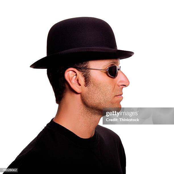 close-up profile of a man wearing a bowler hat and sunglasses - bowler hat stock pictures, royalty-free photos & images