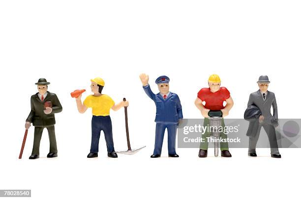 plastic figurines of all walks of life including preacher, miner, policeman, construction worker, and businessman - figurine stock pictures, royalty-free photos & images