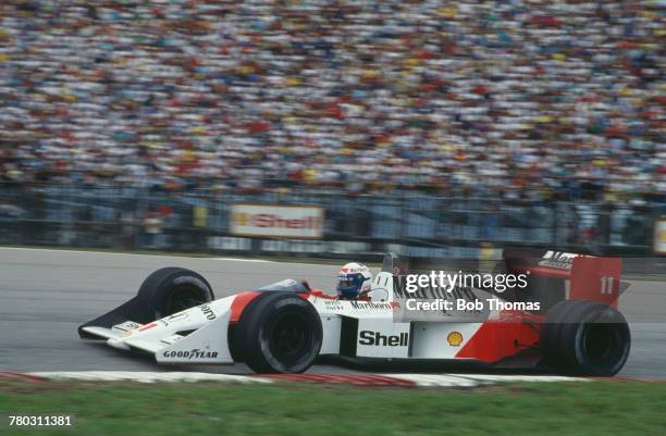 French racing driver Alain Prost drives the Honda Marlboro McLaren McLaren MP4/4 Honda V6 turbo to finish in first place to win the 1988 Brazilian...