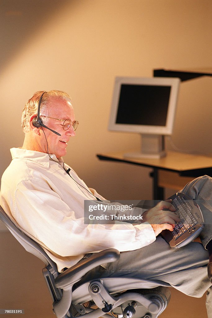 Man with computer and headset